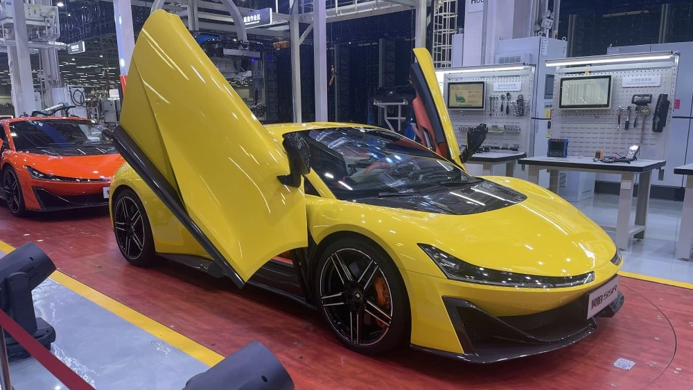 Электрический гиперкар GAC Aion Hyper SSR желтый сбоку спереди двери-ножницы