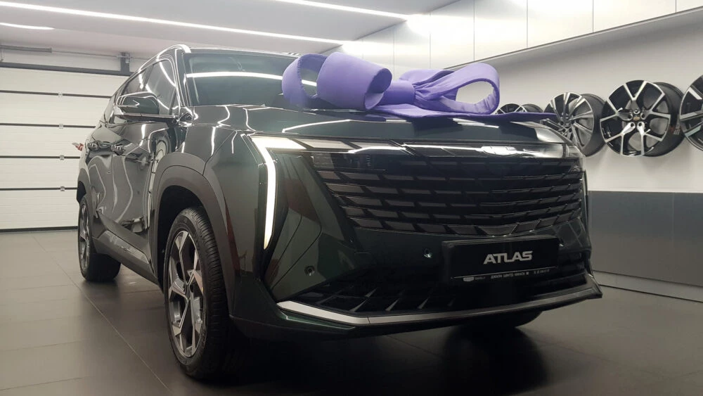 В Минске «внезапно» презентовали Geely Atlas New. Названа цена единственной комплектации Geelу Atlas New в Беларуси сбоку спереди у дилера