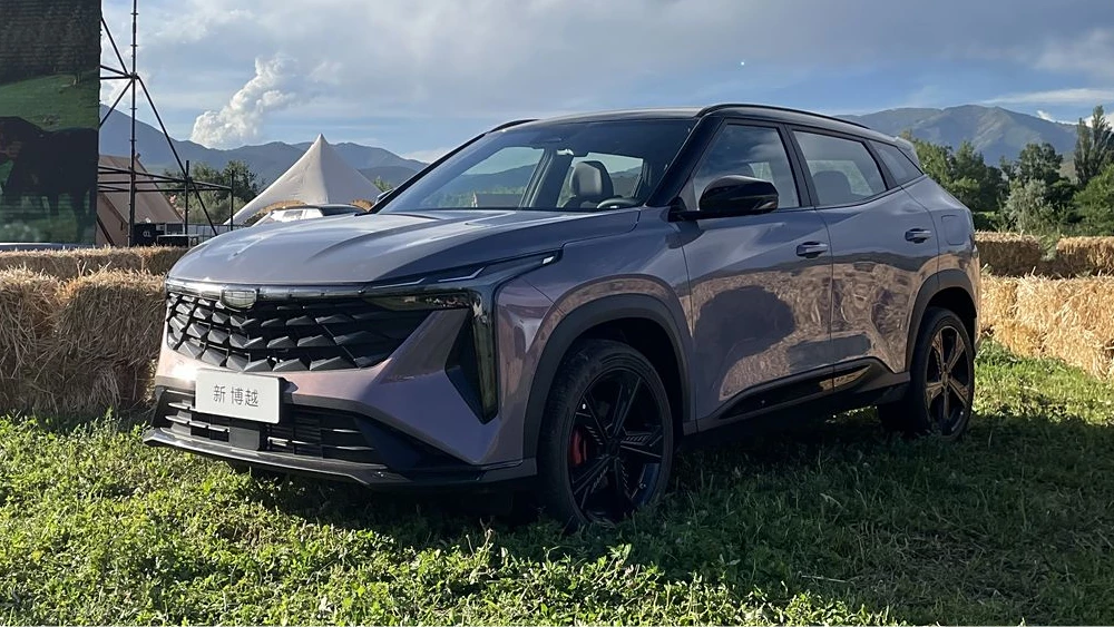 обновлённый кроссовер geely atlas cool 2024 год сбоку спереди фиолетовый