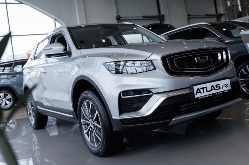 Новый Geely Atlas Pro у дилера в автосалоне купить сбоку спереди бизнес кар лосиный остров