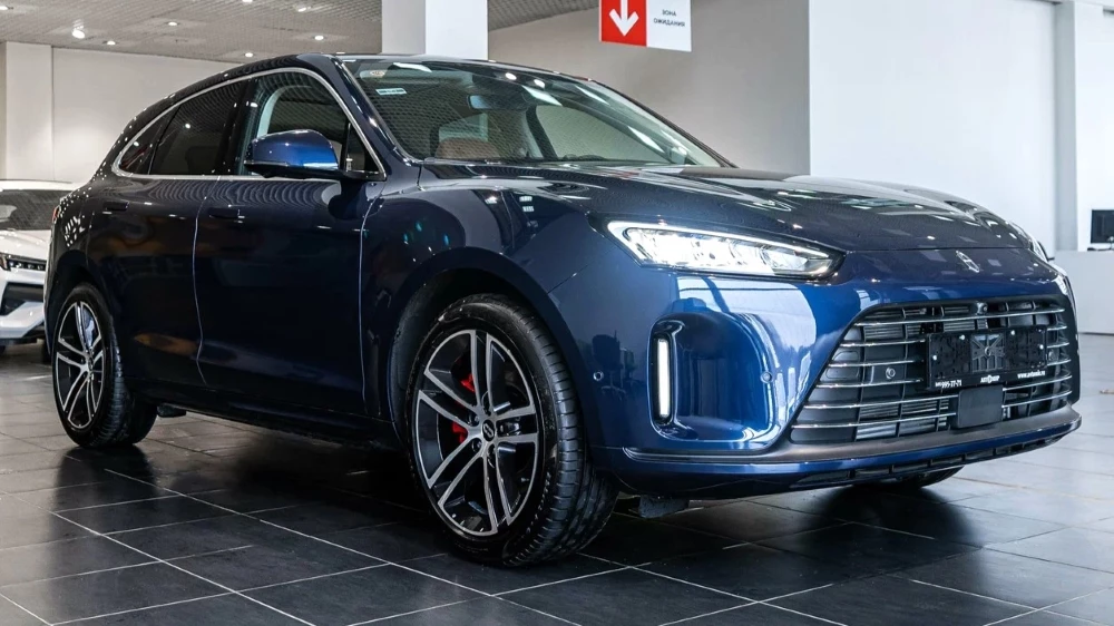 Кроссовер Aito M5 сбоку спереди у дилера в автосалоне ДЦ Автомир