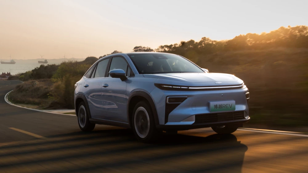 Новый кроссовер Geely Atlas REV стал доступен к заказу в Китае сбоку спереди последовательный гибрид голубой в динамике